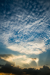 Sun rays through clouds like an dramatic explosion , power nature background.