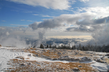 View above the clouds in winter from mountain Schöckl near Graz, Austria