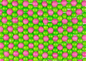 background of green and pink sugar coated candies