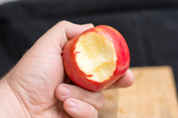 male hand holding apple