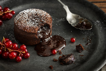 Chocolate Lava Cake with Gooey Molten Center Pouring on to Plate - obrazy, fototapety, plakaty