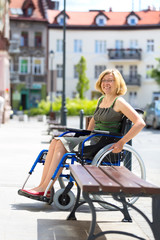 young adult woman on wheelchair on the street