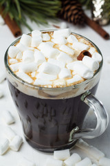 cocoa, coffee with marshmallows on the background of a Christmas tree, fir cones, the concept of the new year and Christmas.