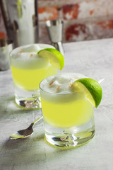 Two Pisco Sour Cocktails in Rocks Glasses with Bartending Tools on Bar Top