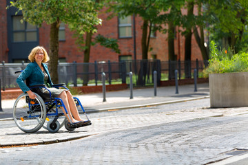 woman on wheelchair crossing the street