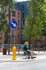 woman on wheelchair crossing the street
