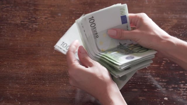 A woman's hands counting three thousand euros. 4K. Without post-editing