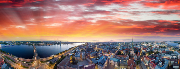 Riga, Latvia. City skyline and river at night - Aerial view