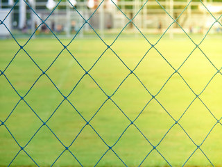 Fototapeta premium Blue soccer stadium net and green field with no one on