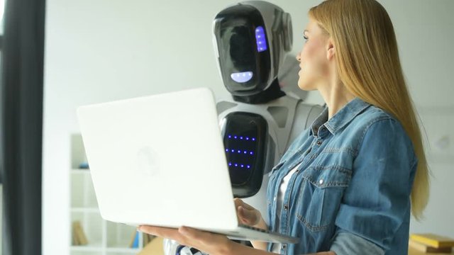 Woman and robot working as team in office