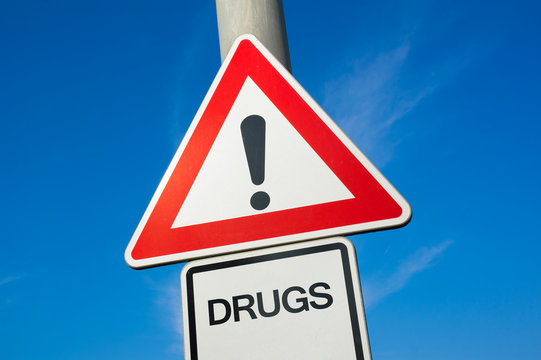 Drugs - Traffic Sign With Exclamation Mark To Alert, Warn Caution - Substance Abuse And Misuse Leading To Addiction And Being Addict