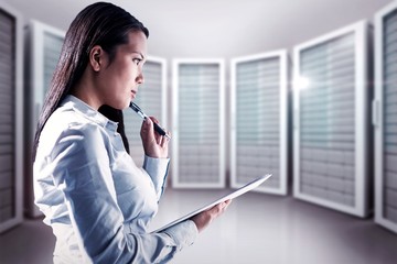 Composite image of thoughtful woman with pen on cheek holding