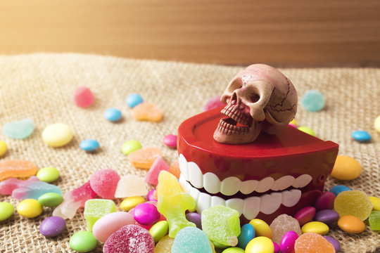 skull on teetch toywith candy colorful in halloween concept