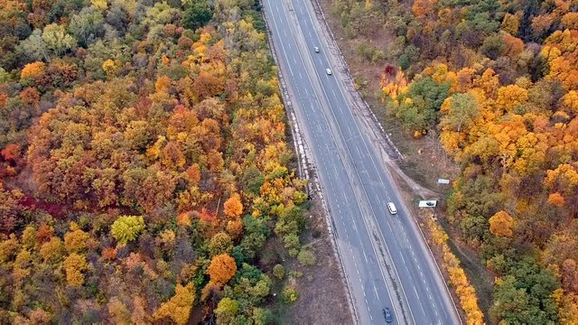 Aerial autumn view near the road with cars in Eastern Europe. Cloudy weather.