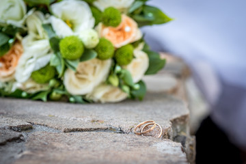 Wedding rings on a bouquet background