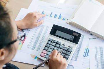 woman hand using calculator and writing make note with calculate