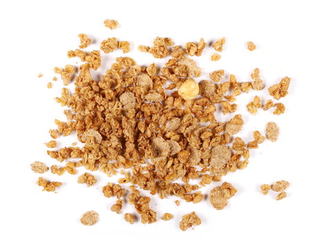 Crunchy granola, muesli pile with nuts isolated on white background, top view