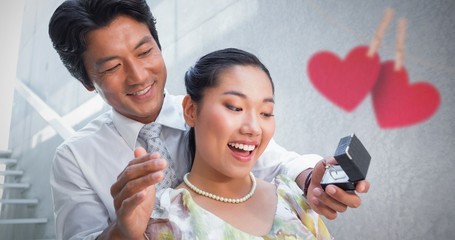 Composite image of man proposing marriage to his shocked