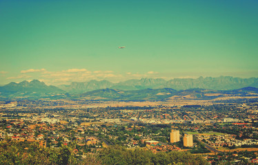 Wonderful vintage. Matte background. Aerial view at the city and mountains. Panoramic skyline. Amazing landscape. Retro postcard.