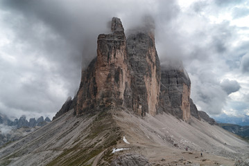 Side profile of cloud-covered Drei Zinnen in the Dolomites