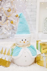 Snowman and New Year's gifts close-up in the interior
