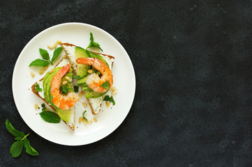 Sandwich with avocado, goat cheese, shrimp and arugula. View from above.