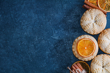 Top view of mince pies, baked crumbly pastry packed with fruits, tangy peel and spices. Concept of...