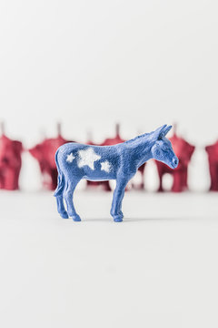 United States Democratic Donkey infront of a Row of Republican Elephants
