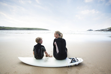 Mother and Son surfing together.