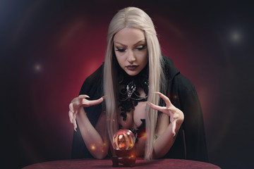 Young witch with silver hair casting a spell, invoking spirits and being possessed
