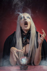 Young witch with silver hair casting a spell, invoking spirits and being possessed