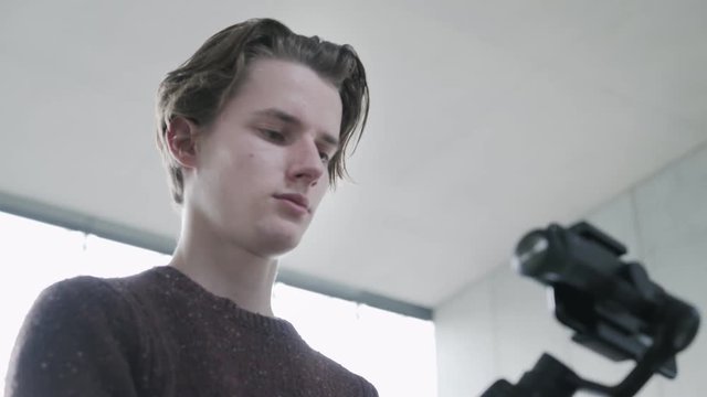 The operator makes a video shoot for his Internet channel using a stabilizer and a mobile phone