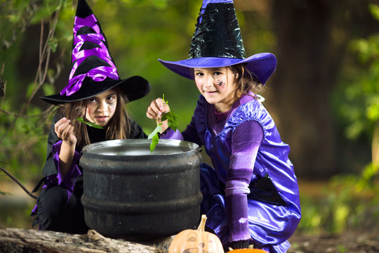 Two little witches cooking