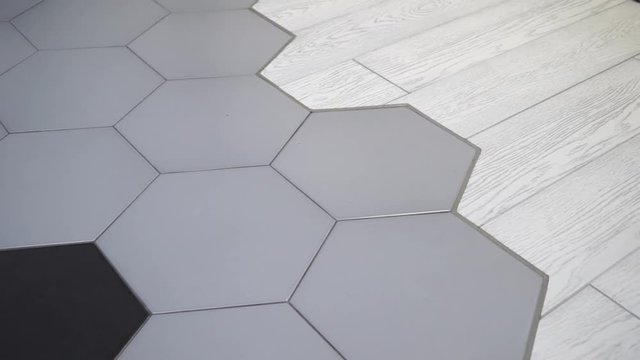 joint of ceramic tiles and parquet. repair in the apartment.