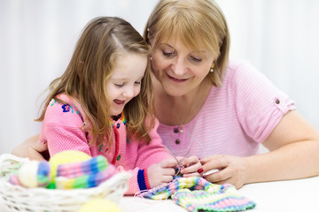 Obraz na płótnie Canvas Mother and child knitting. Knit wear. Crafts with kids.