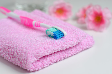 Pink toothbrush on a pink towel