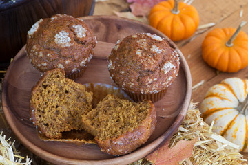 Delicious Pumpkin Muffins on a Wooden Plate