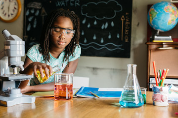 Girl doing a chemistry experiment in science class