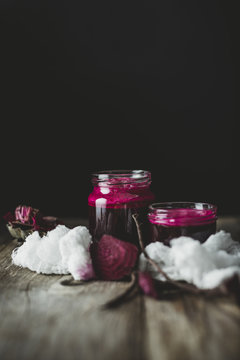 Homemade beetroot juice in jars on wooden table