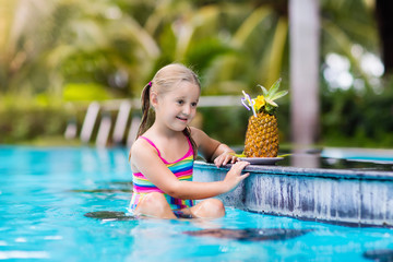 Child with pineapple juice in pool bar