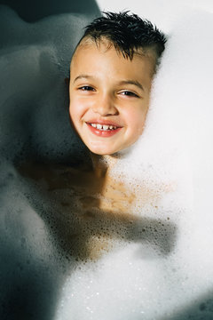 Portrait of smiling boy in bubble bath