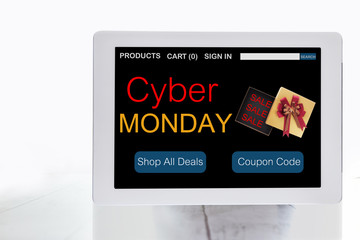 Online shopping website with cyber monday sale on computer tablet screen on wooden desk