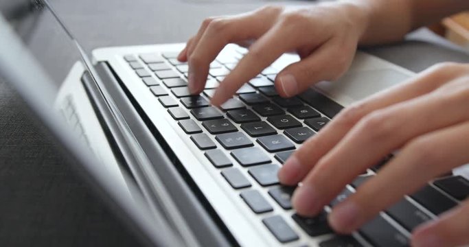 Typing on laptop computer keyboard