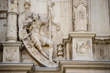 Fototapeta na wymiar Details of stone sculptures of the facade of the University of Alcalá de Henares. Madrid, Spain.