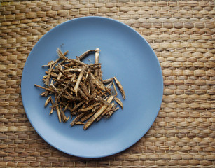 Fang feng or saposhnikovia divaricata (siler) roots close up look on neutral background. Top view.