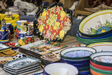 hand-painted dishes of a multitude of colors in a traditional art market