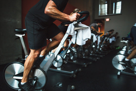 Anonymous caucasian man working hard during spin cycle class