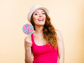 Woman holds colorful lollipop candy in hand
