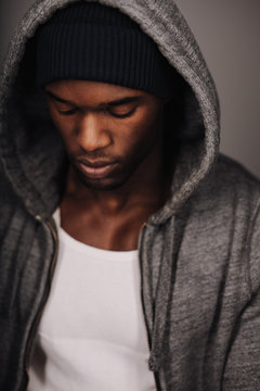 Close up shot of calm young man looking down thinking