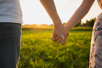 A couple holding hands. Closeup